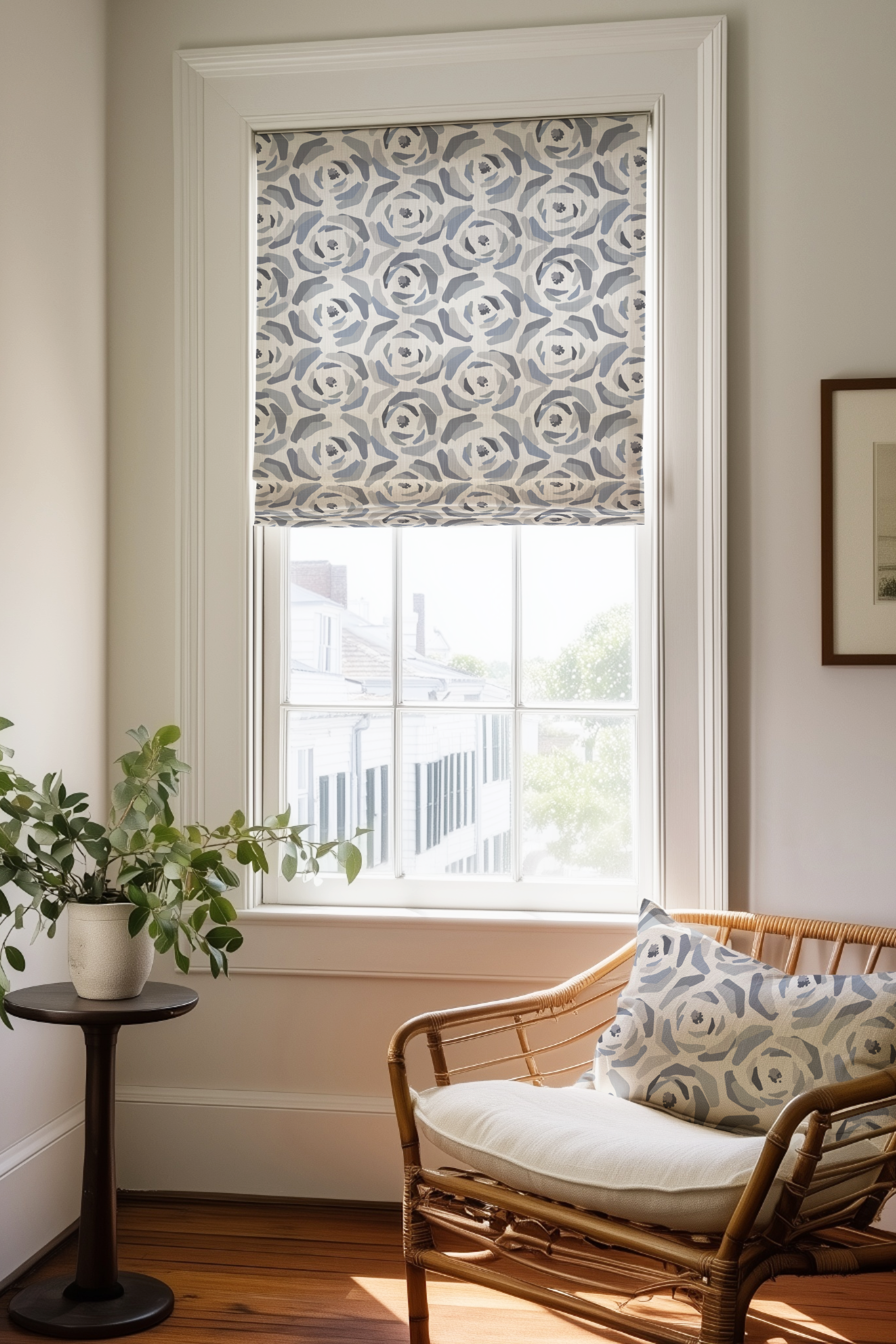 Corner of a bedroom in a Charleston home with a Roman shade and pillow in Magnolia fabric in Slate by Emily Daws.