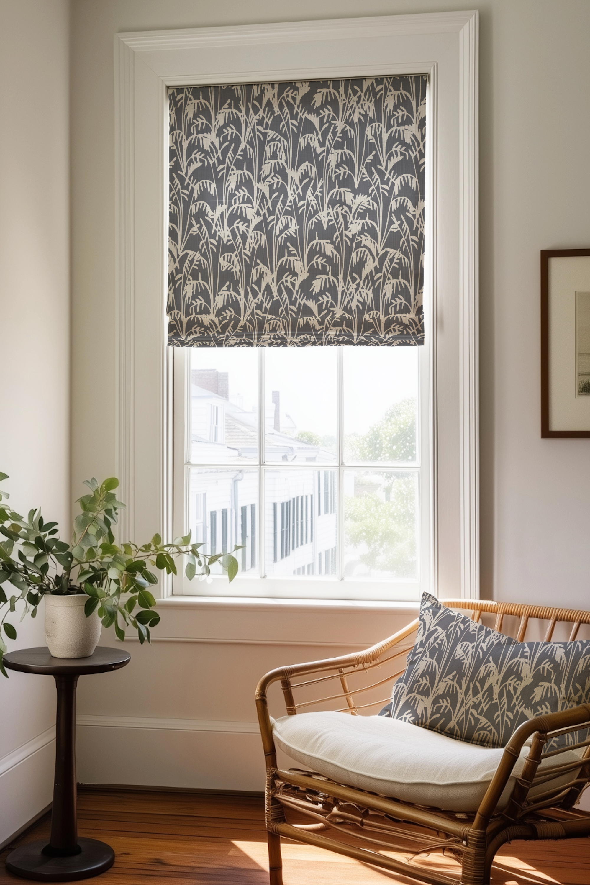 Corner of a bedroom in a Charleston home with a Roman shade and pillow in Seabrook fabric in Storm by Emily Daws.