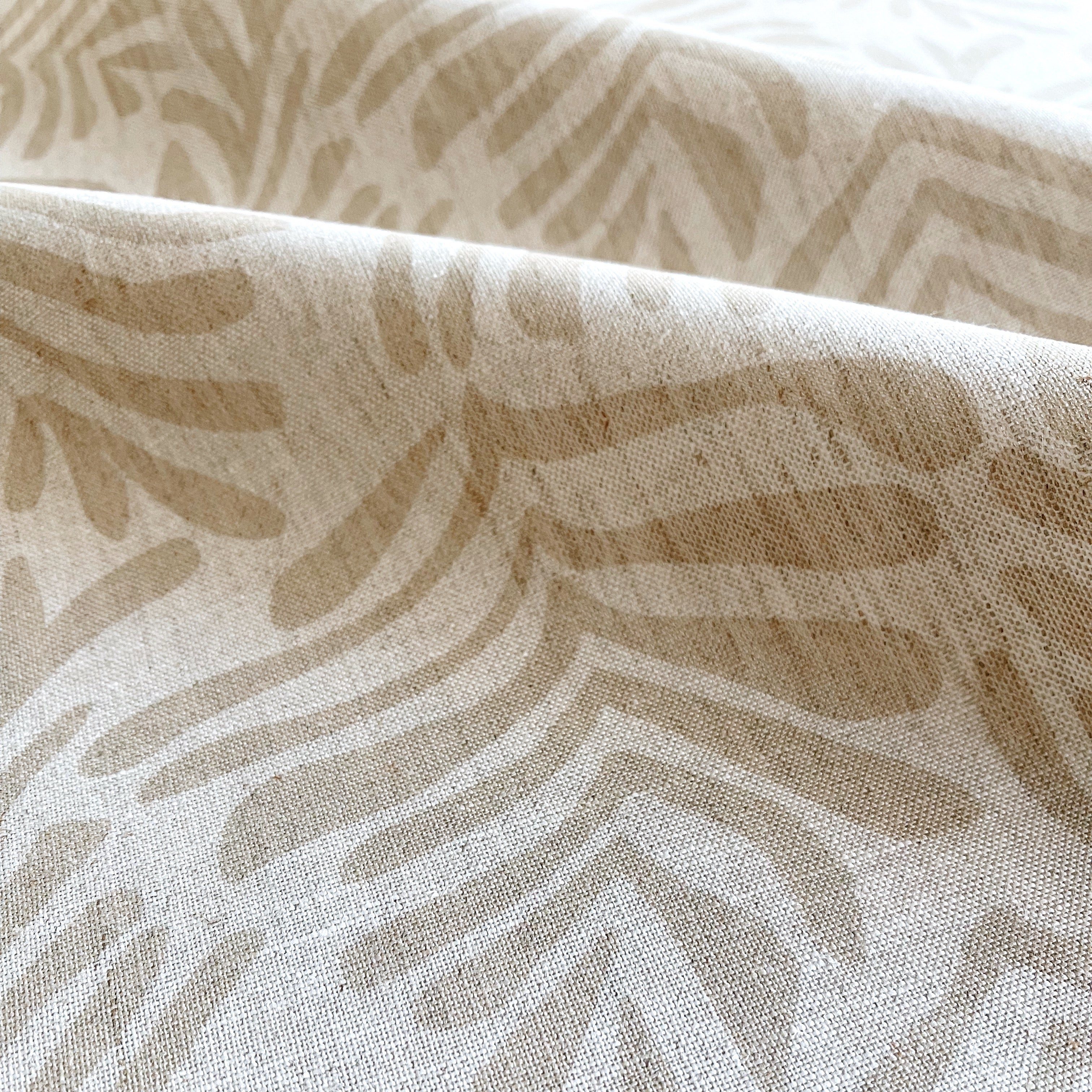 Frond fabric in Truffle – close-up of linen texture and leafy pattern; perfect for pattern sofas